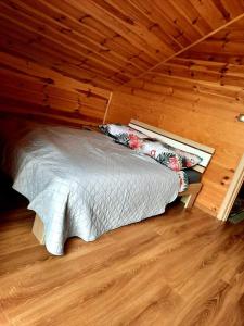 a bed in a room with a wooden ceiling at Domek Chańcza in Chańcza