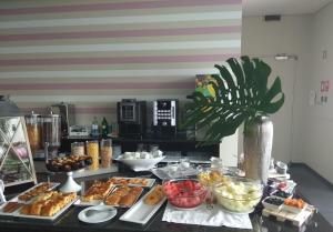 a buffet with many different types of food on a table at Hotel Monte Lírio in Espinho