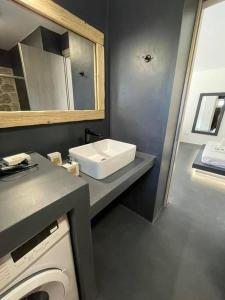 Rock N Sun - Brand new apartment in Ermioni في إرميوني: حمام مع مغسلة وغسالة ملابس