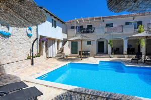 a villa with a swimming pool and a house at Didovi dvori in Bibinje
