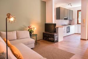 un salon avec un canapé et une cuisine dans l'établissement S255 - Sirolo, nuovo trilocale a due passi dal centro, à Sirolo 16 autres photos