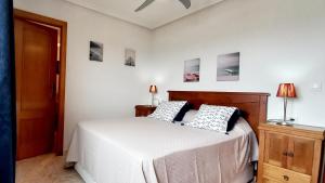 A bed or beds in a room at Gran Playa View Apartment