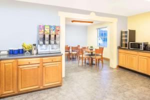 a kitchen and dining room with a table and chairs at Days Inn by Wyndham Roanoke Near I-81 in Roanoke