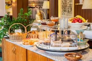 a buffet with baskets of food on a counter at Parkhotel Crombach am Salingarten in Rosenheim +59 photos