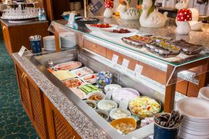a buffet line with many different types of food at Parkhotel Crombach am Salingarten in Rosenheim
