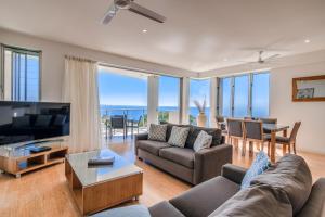 a living room with a view of the ocean at Rainbow Ocean Palms Resort in Rainbow Beach