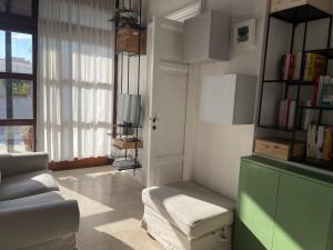 a living room with a couch and a tv at #soloperte B&B apartments in Molfetta