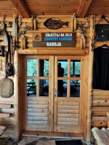 a front door of a log cabin at Apatments Radoja - Pliva in Šipovo