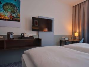 Ein Bett oder Betten in einem Zimmer der Unterkunft Dorint Parkhotel Frankfurt / Bad Vilbel