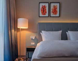 Ein Bett oder Betten in einem Zimmer der Unterkunft Dorint Parkhotel Frankfurt / Bad Vilbel