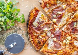 a pizza sitting on top of a table with a pizza cutter at Viking Line ferry Viking Glory - Mini-cruise from Stockholm in Stockholm