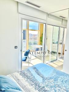 a bedroom with a bed and a balcony at INTEMPO SKY Resort & Spa in Benidorm