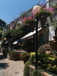a building with flowers on the side of it at AUGUSTUS PARK Capri Center in Capri