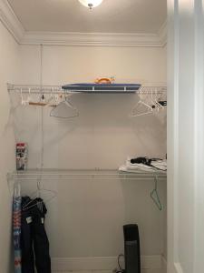 a walk in closet with two shelves and two lights at Blue Sky in Fort Myers