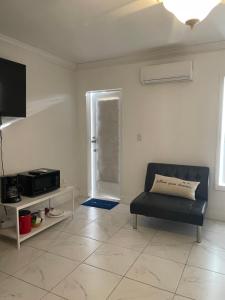 a living room with a couch and a tv at Blue Sky in Fort Myers