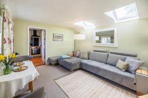 a living room with a couch and a table at The Stable Grundisburgh Air Manage Suffolk in Woodbridge