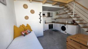 a small kitchen with a staircase in a room at Tiny House Faro in Faro