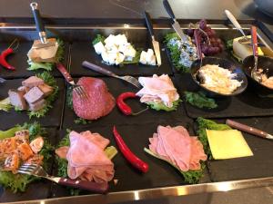 a cutting board topped with lots of different types of food at Aksjemøllen - by Classic Norway Hotels in Lillehammer