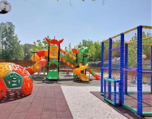 a park with a playground with slides and play equipment at CAMPING CALATELLA parco di vacanza in Marina di Massa