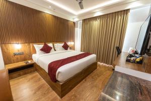a bedroom with a large bed in a room at Clarks Inn , Airport Bangalore in Yelahanka