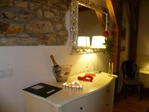 a room with a table with a mirror on the wall at Dolce Vita Suites Boutique in Prague