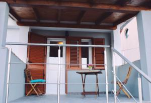 a balcony of a house with a table and chairs at Apartment VistaMare Croatia in Luka