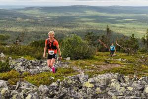 a woman running on top of a mountain at Ski-Inn Hotel Pyhätunturi in Pyhätunturi