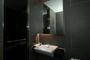 a bathroom with a sink and a mirror at Hotel The Designers Hongdae in Seoul