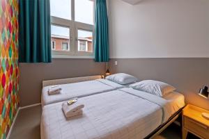 
a bedroom with a bed and a window at Stayokay Hostel Den Haag - Fully Renovated per April 2022 in The Hague
