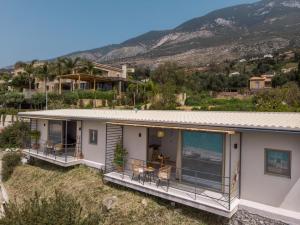 a house with a view of the ocean at Thea Suites in Lourdata