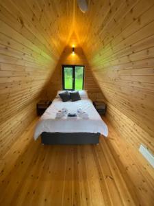 a bedroom with a bed in a wooden cabin at Countryside Cabin in Taunton