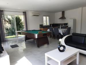 a living room with a pool table in it at GITE COTE LAC in Valréas