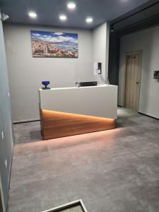 an office with a desk and a painting on the wall at Mia Suites Hotel Bella Capri in Naples