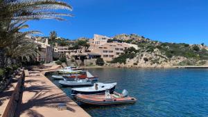 a group of boats are docked in a river at Grecalotto Apartment in La Maddalena