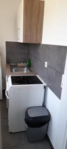 a small kitchen with a stove and a sink at My Sweet Home City in Düsseldorf