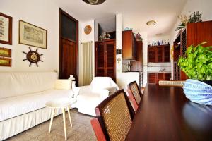a living room with a table and a couch at MAL Portovenere Apartment in Portovenere