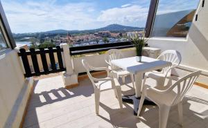 a white table and chairs on a balcony with a view at Cyllène Port Nature 5 in Cap d'Agde +5 photos
