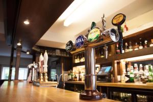 a bar with a counter with lots of bottles at The Lordleaze Hotel And Restaurant in Chard