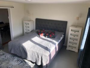 a bedroom with a bed with two night stands and two lamps at Grindhuset in Skottorp