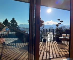a sliding glass door with a view of the mountains at Tegernsee - Seeblick, Terrasse, Berge in Tegernsee