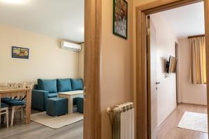 a living room with a blue couch and a table at City Apartments 2 in Velingrad