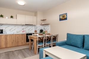 a living room with a couch and a table and a kitchen at City Apartments 2 in Velingrad