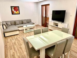 a living room with a table and a couch at Apartments Family in Tivat