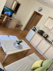 a living room with a table and a kitchen at Good Vibes apartment Avalon in Sunny Beach