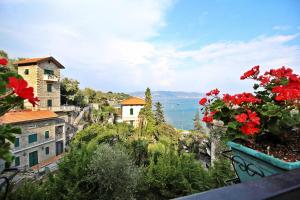 a view of a city with red flowers in a pot at MAL Portovenere Apartment in Portovenere