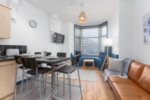 a kitchen and living room with a table and a couch at Blackpool Lodge Apartments in Blackpool