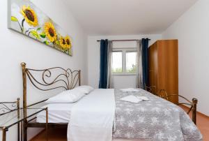 a bedroom with a bed and a window at Apartments Milan in Rakalj