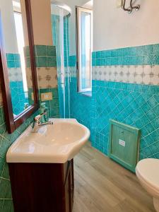 a bathroom with a sink and a mirror at Affittacamere Ciro's House in Olbia