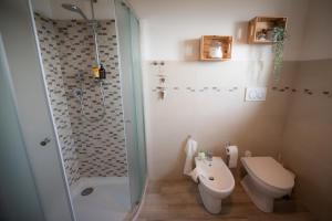 a bathroom with a shower and a toilet and a sink at Casale Monte Valestra in Bebbio