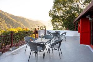 a group of tables and chairs on a patio at ROSASTAYS Jeolikote in Nainital